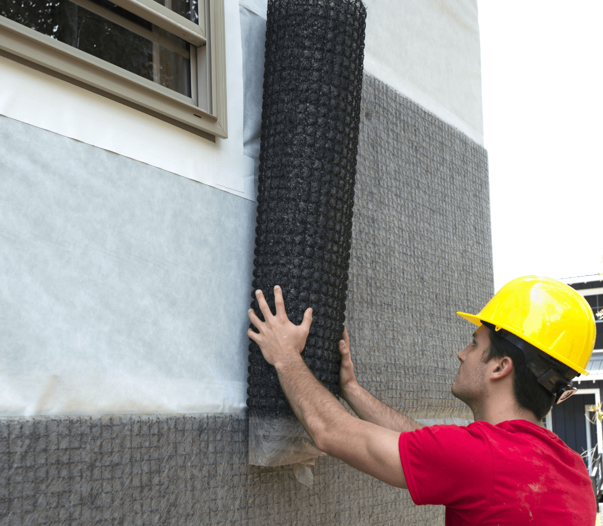 Contractor installing Rainscreen drainage mat EnkaWallDrain on outer wall Credits Enka Solutions_©Low&Bonar